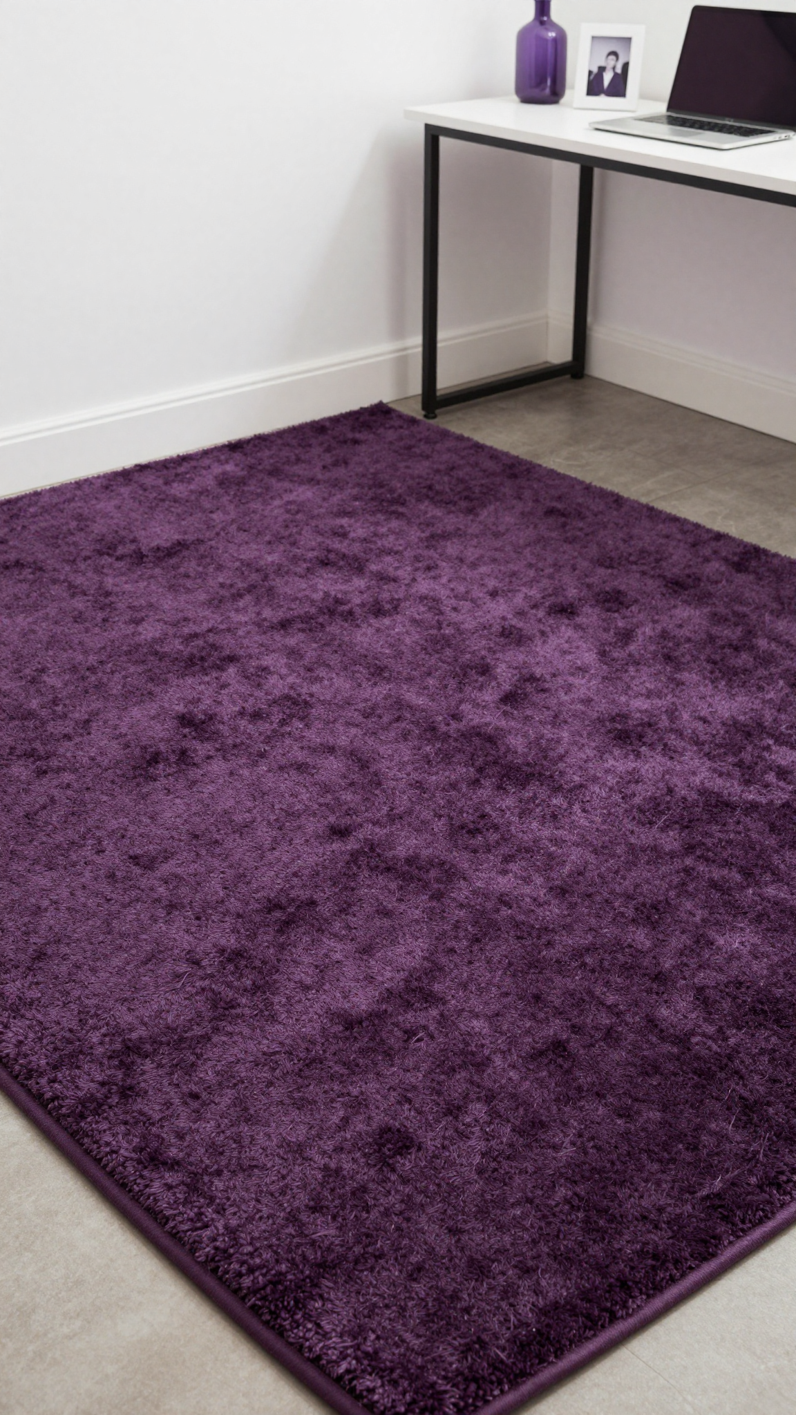 Plum area rug with plush shag texture in a dorm room with a desk and decor
